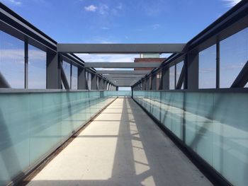 View of walkway against blue sky