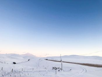 Scenic view of snow covered mountains against clear sky