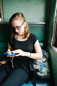 Young woman sitting on book