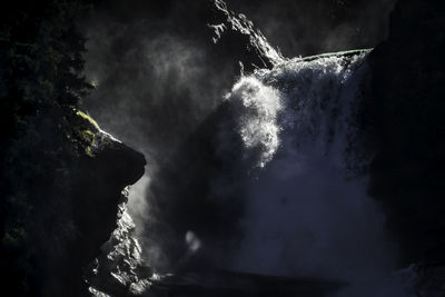 Low angle view of waterfall against sky at night