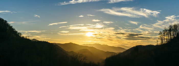 Scenic view of silhouette mountains against sky at sunset