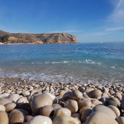 Rocks on beach against sky