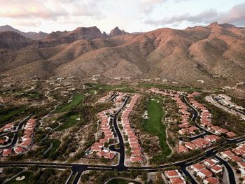 High angle view of land and mountains against sky