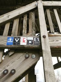 Low angle view of arrow sign on wood