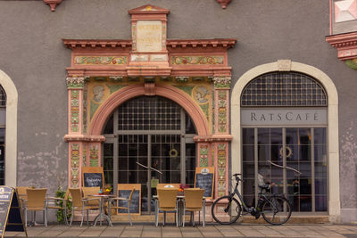 Bicycles on table by building in city