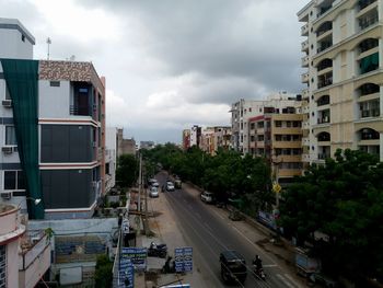 Cars on road in city against sky