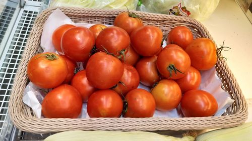 High angle view of tomatoes in basket on table at market