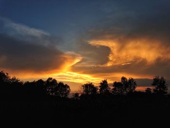 Silhouette trees against sky during sunset