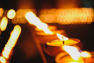 Close-up of burning oil lamps