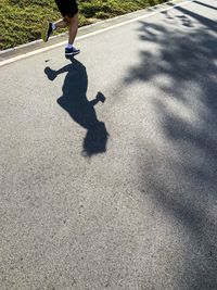 Low section of man skateboarding on street