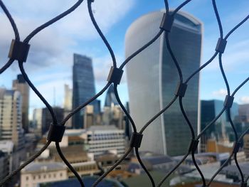 Close-up of chainlink fence against sky