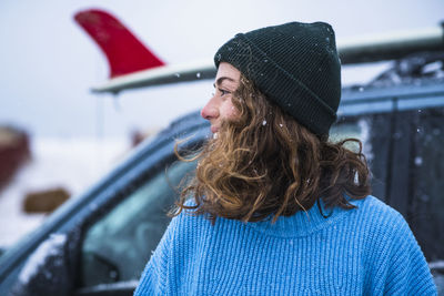 Woman surfer portrait with frozen surfboard