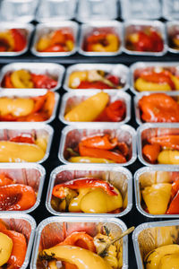 Pre-portioned gourmet roasted bell peppers in trays. 