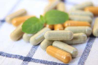 Close-up of pills spilling from bottle