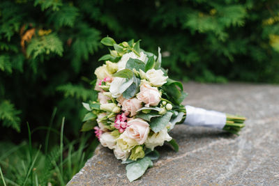 Wedding beautiful rustic bouquet of flowers on the old stone
