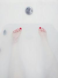 Low section of woman in bathtub