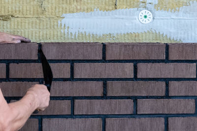 Close-up of man hand on wall