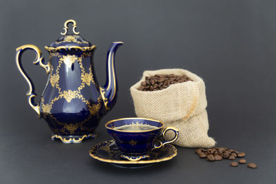 Close-up of coffee cup on table against black background