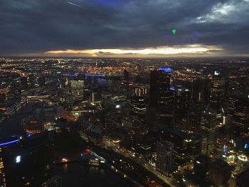 High angle view of illuminated city against sky at night