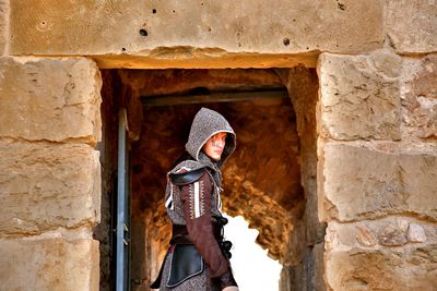 Portrait of man in costume standing at doorway