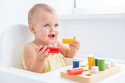 Boy playing with toy blocks in bathroom