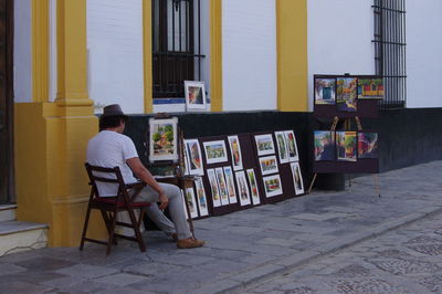 Full length of woman sitting on wall