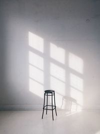 Stool against white wall at home
