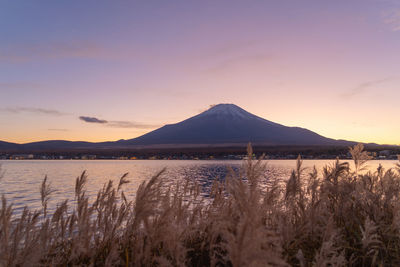 Scenic view of lake against sky during sunset