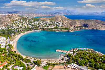 High angle view of residential district and sea against sky