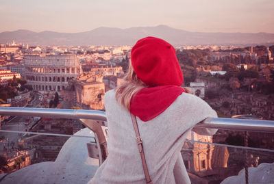 Rear view of woman looking at city in winter