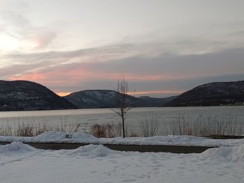 Scenic view of snowcapped mountains against sky during sunset