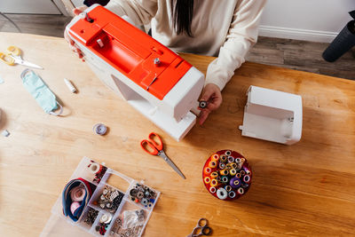 High angle view of woman holding toy on table