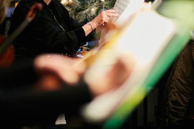 Cropped image of musician reading sheet music