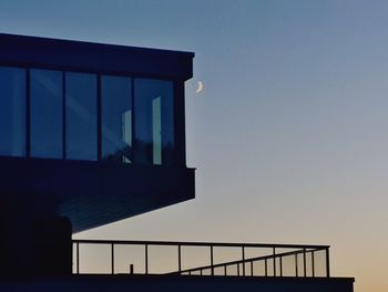 Low angle view of silhouette building against sky at dusk