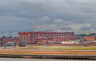 View of town against cloudy sky