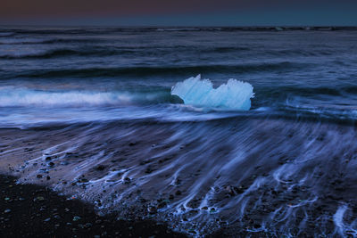 Iceberg on beach at jokulsarlon glacial lagoon