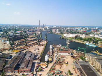 High angle view of buildings and sea against sky