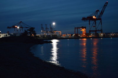 View of illuminated harbor at night