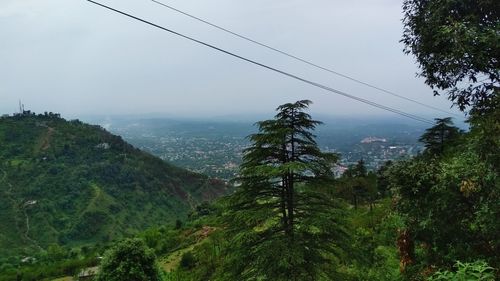 Scenic view of trees and mountains against sky