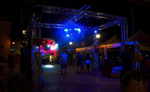 Group of people in illuminated building at night