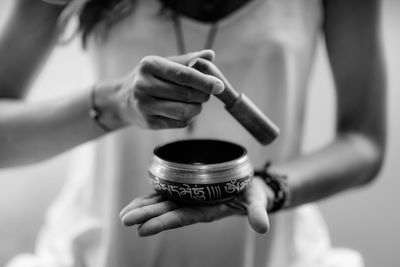 Close-up of woman holding singing bowl