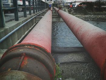 Close-up of metal pipes on bridge in city