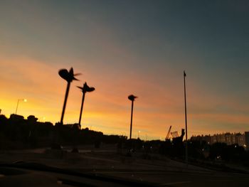 Silhouette of street light against sky at dusk