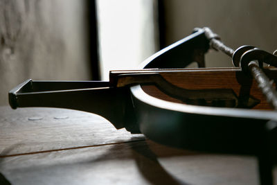 Close-up of cross bow on table