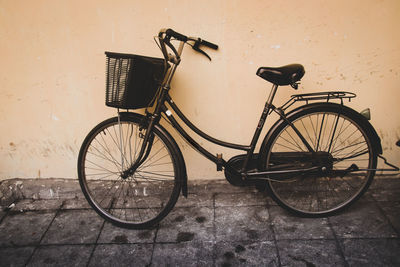 Bicycle on street by wall