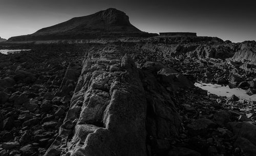 Low angle view of rock formation on land against sky