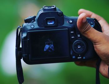 Close-up of hand holding camera