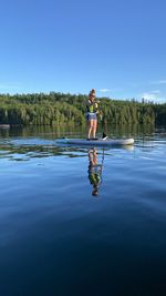 Woman on paddlebording on lake 