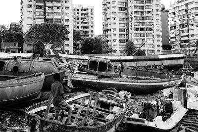 Abandoned boats moored in city