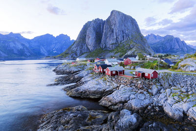 Scenic view of sea and mountains against sky